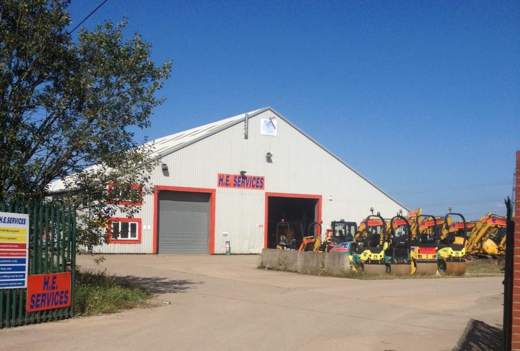 Cambridge depot image from outside showing blue skies and rollers and diggers lined up